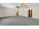 Spacious living room featuring grey carpeting, ceiling fan, and wood trim at 4859 W 150 N, Greenfield, IN 46140