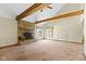 Living room features a stone fireplace, wood beams, and ample natural light at 4859 W 150 N, Greenfield, IN 46140