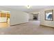 Large open room featuring carpet and an entrance to the kitchen and another living space at 4859 W 150 N, Greenfield, IN 46140
