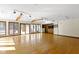 Spacious living room with wood floors, beamed ceilings, and large windows offering scenic views of the outdoors at 4859 W 150 N, Greenfield, IN 46140
