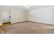 Simple living room with neutral walls, carpet flooring, and baseboard trim at 4859 W 150 N, Greenfield, IN 46140