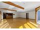 Bright and airy living room with wood floors, beamed ceilings, and an open layout connecting to the kitchen at 4859 W 150 N, Greenfield, IN 46140
