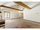 Spacious living room with high ceilings, wood beams, and a large window at 4859 W 150 N, Greenfield, IN 46140