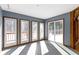 Bright sunroom with tile floors, multiple doors to the deck and a stained glass accent at 4859 W 150 N, Greenfield, IN 46140