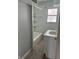 Bathroom featuring gray walls, a shower-tub combo, and a single sink vanity at 5139 S Keystone Ave, Indianapolis, IN 46227
