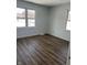 Bright bedroom featuring laminate flooring, gray walls, and two windows providing natural light at 5139 S Keystone Ave, Indianapolis, IN 46227