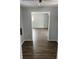 Hallway featuring modern laminate flooring and gray paint leading to additional rooms in the home at 5139 S Keystone Ave, Indianapolis, IN 46227