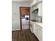 View of the laundry room with a washer and dryer with an entry door and a gas range in the kitchen at 5139 S Keystone Ave, Indianapolis, IN 46227