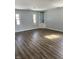 Light-filled living room with laminate flooring, neutral walls, and a built-in shelving unit at 5139 S Keystone Ave, Indianapolis, IN 46227
