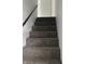 Carpeted stairway with a wood railing, leading to the upper level of the home at 5139 S Keystone Ave, Indianapolis, IN 46227