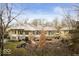 Beautiful home featuring stone accents, mature trees, and a well-maintained yard at 5400 W Deer Run Ct, Muncie, IN 47304