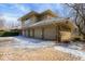 Spacious three-car garage with stone accents and a well-maintained brick driveway at 5400 W Deer Run Ct, Muncie, IN 47304