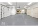 Spacious four-car garage with ample storage, neutral paint, and multiple doors at 5400 W Deer Run Ct, Muncie, IN 47304