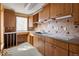 Functional kitchen with plenty of counter space and custom tiled backsplash at 5400 W Deer Run Ct, Muncie, IN 47304