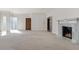 Spacious living room with fireplace, large windows and doorway to entry and door to outside at 5400 W Deer Run Ct, Muncie, IN 47304