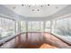 Sun room featuring hardwood floors and large windows offering abundant natural light and views at 5400 W Deer Run Ct, Muncie, IN 47304