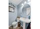 Charming powder room featuring a pedestal sink, stylish mirror, and a toilet, providing a fresh and functional space at 5415 Honey Comb Ln, Indianapolis, IN 46221