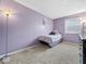 Cozy bedroom featuring soft carpeting, a window for natural light, and decor, creating a peaceful and relaxing ambiance at 5415 Honey Comb Ln, Indianapolis, IN 46221
