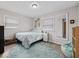 Bright bedroom featuring a blue rug, natural light, and cozy decor, providing a comfortable and relaxing retreat at 5415 Honey Comb Ln, Indianapolis, IN 46221