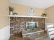 Close-up of a brick fireplace with a mantel and decorative accents in the dining room at 5415 Honey Comb Ln, Indianapolis, IN 46221
