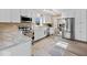 Well-lit kitchen with stainless steel appliances, white cabinets, and wood-look flooring at 5415 Honey Comb Ln, Indianapolis, IN 46221