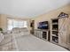 Comfortable living room featuring neutral carpeting, modern media center, and bright natural light, creating a relaxed atmosphere at 5415 Honey Comb Ln, Indianapolis, IN 46221