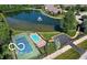 Aerial view of the community showcasing the pond, swimming pool, tennis courts, and lush landscaping at 6641 Stone Pointe Way, Indianapolis, IN 46237