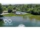 Scenic aerial view of the community pond, pool, tennis courts, and surrounding green spaces at 6641 Stone Pointe Way, Indianapolis, IN 46237
