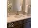 Bathroom featuring a decorative mirror, quartz counters, and bronze fixtures at 6641 Stone Pointe Way, Indianapolis, IN 46237