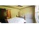 Spacious bedroom boasts a tray ceiling with fan, large windows, and a barn door to the bathroom at 6641 Stone Pointe Way, Indianapolis, IN 46237