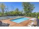 Relaxing community pool area with lounge chairs, tennis courts, and picturesque landscaping at 6641 Stone Pointe Way, Indianapolis, IN 46237