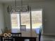 Dining room with modern lighting fixture, table, chairs, and sliding door at 6641 Stone Pointe Way, Indianapolis, IN 46237