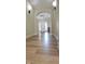 Elegant hallway featuring hardwood floors, arched doorways, and modern lighting fixtures at 6641 Stone Pointe Way, Indianapolis, IN 46237
