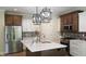 Kitchen with stainless steel appliances, white quartz countertops, and island sink at 6641 Stone Pointe Way, Indianapolis, IN 46237