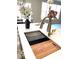Kitchen island sink with stainless steel fixtures and cutting board at 6641 Stone Pointe Way, Indianapolis, IN 46237