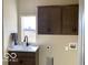 Neutral toned laundry room featuring a sink, faucet, and natural light from the window at 6641 Stone Pointe Way, Indianapolis, IN 46237