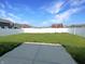 Fenced backyard with a view of neighboring homes under a blue sky, providing a secure area at 673 Ballycastle Ct, Pendleton, IN 46064