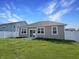 Backyard featuring a well-maintained lawn, patio, and white fence, offering a private outdoor space at 673 Ballycastle Ct, Pendleton, IN 46064