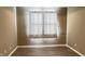 Neutral bedroom featuring wood-look flooring and a window with sheer curtains at 673 Ballycastle Ct, Pendleton, IN 46064