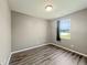 Cozy bedroom with wood-look flooring, large window, and neutral paint at 673 Ballycastle Ct, Pendleton, IN 46064