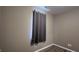Wall of bedroom featuring a window with dark curtains, hardwood floors, and a neutral color palette at 673 Ballycastle Ct, Pendleton, IN 46064