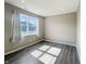 Bright bedroom with wood-look flooring, large window, and neutral paint at 673 Ballycastle Ct, Pendleton, IN 46064