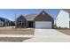 Charming brick home with a well-manicured lawn and a two-car attached garage on a sunny day at 673 Ballycastle Ct, Pendleton, IN 46064