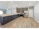 Modern kitchen featuring stainless steel appliances, gray cabinets, light countertops, and wood-look flooring at 673 Ballycastle Ct, Pendleton, IN 46064