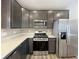 Contemporary kitchen with stainless steel appliances, gray cabinets, and light countertops at 673 Ballycastle Ct, Pendleton, IN 46064