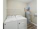 Laundry room equipped with a washer, dryer, and water heater, complemented by overhead shelving at 673 Ballycastle Ct, Pendleton, IN 46064