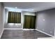 Open-concept living room featuring modern lighting, wood flooring, and large window that provides natural light at 673 Ballycastle Ct, Pendleton, IN 46064