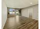 Spacious living room with wood-look flooring, large window, and sliding glass door at 673 Ballycastle Ct, Pendleton, IN 46064