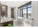 Elegant bathroom showcasing a freestanding tub, stunning city view, and granite countertops at 720 S Rangeline Rd # 601, Carmel, IN 46032