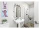 Bathroom featuring a pedestal sink, glass enclosed shower and fun modern art at 720 S Rangeline Rd # 601, Carmel, IN 46032